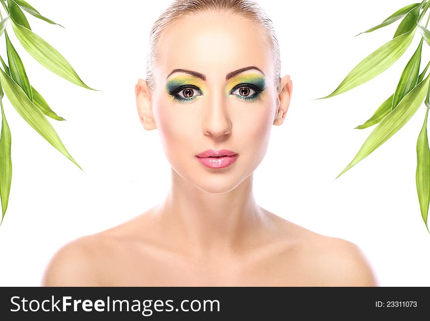 Beautiful blonde with artistic make- up and  bamboo leaves. Beautiful blonde with artistic make- up and  bamboo leaves