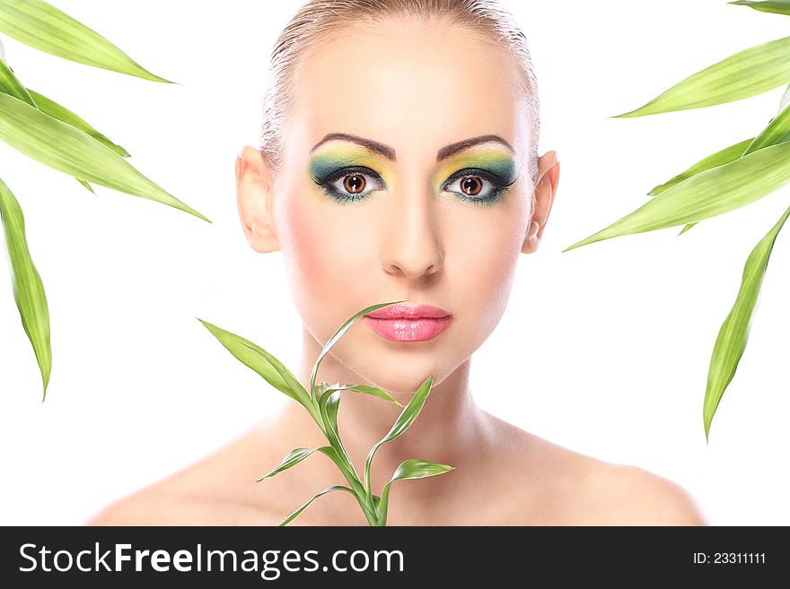 Beautiful blonde with artistic make- up and bamboo leaves. Beautiful blonde with artistic make- up and bamboo leaves