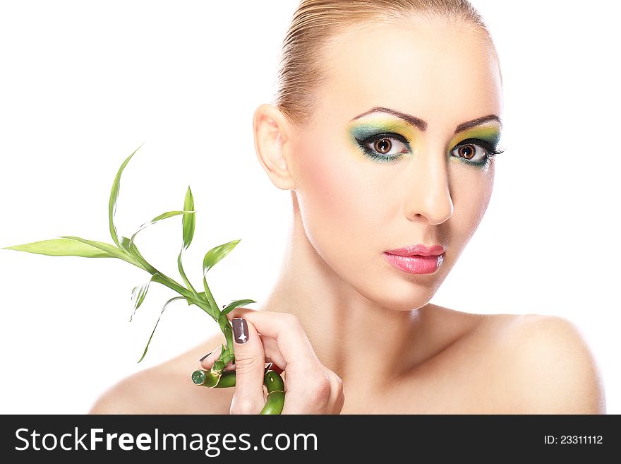 Beautiful blonde with artistic make- up and bamboo leaves. Beautiful blonde with artistic make- up and bamboo leaves