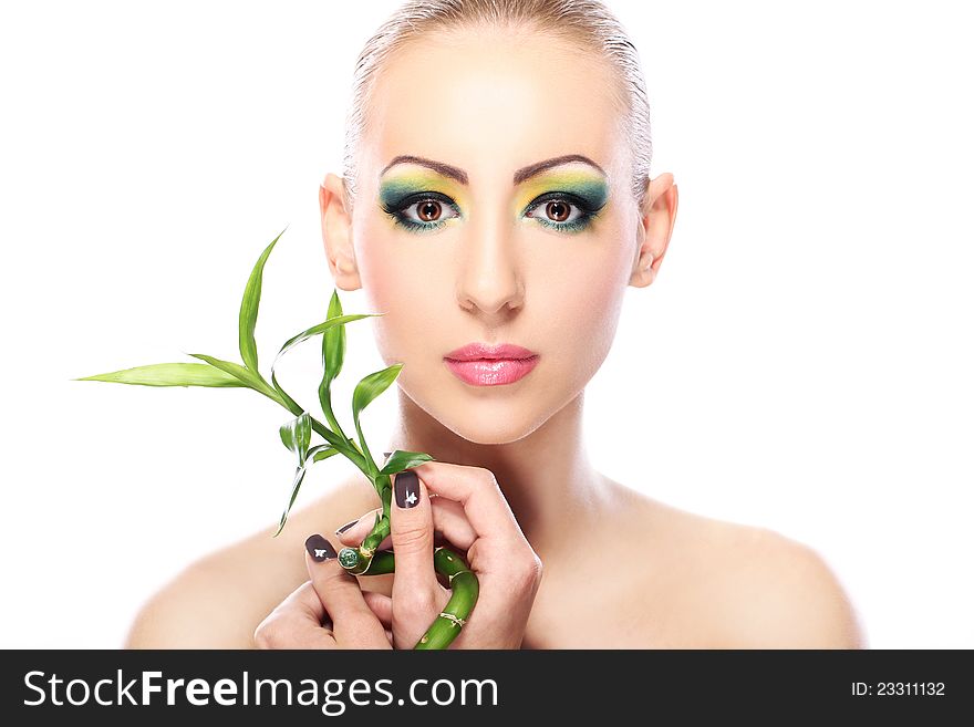 Beautiful blonde with artistic make- up and bamboo leaves. Beautiful blonde with artistic make- up and bamboo leaves