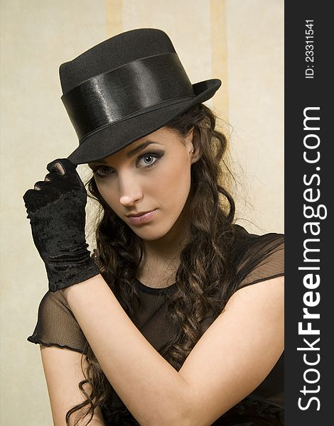 Beautiful young woman in dark hat. Beautiful young woman in dark hat