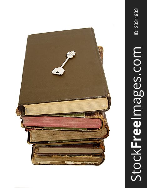 Book and the key of knowledge on a white background