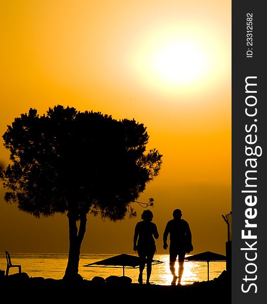 Male and female at sunrise at beach