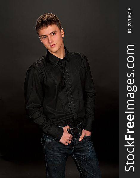 Portrait of young man on dark background. Portrait of young man on dark background.