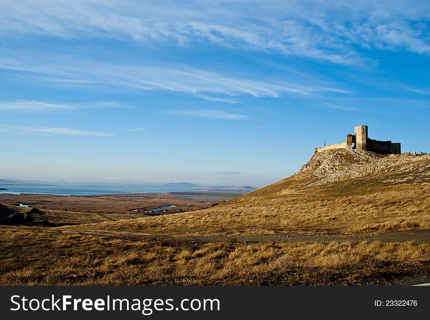 Ruins of medieval fortress Enisala, Romania, Europe. Background with sky and clouds.