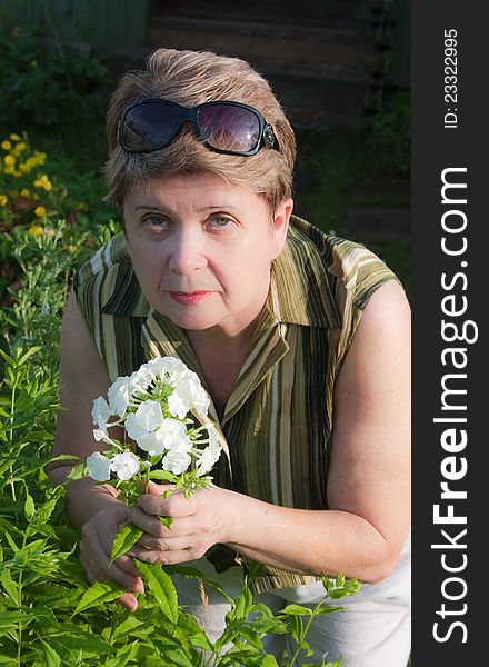 Portrait of a woman with a blooming phlox