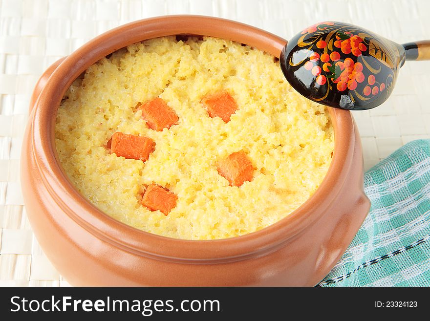 Dairy millet porridge with pumpkin in a ceramic pot