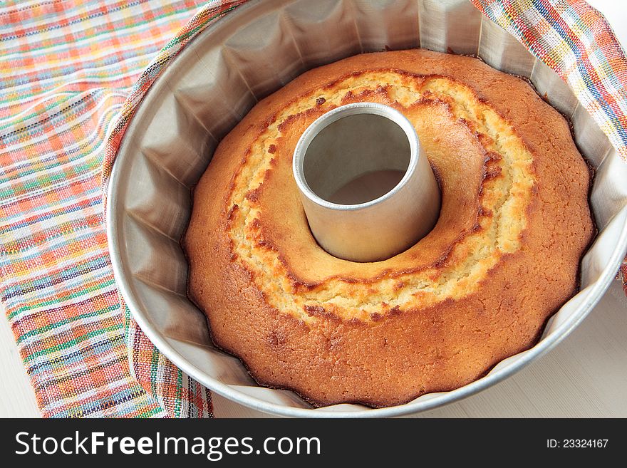 Freshly baked cake in the form of baking