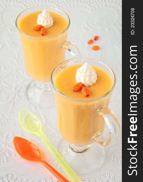 Two glass goblets with mousse of sea-buckthorn and whipped cream