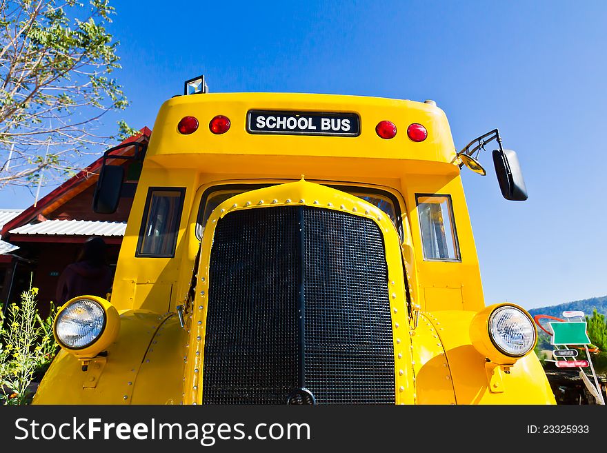 Yellow school bus against blue sky