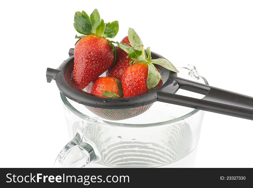 Colander with strawberry isolated on white background