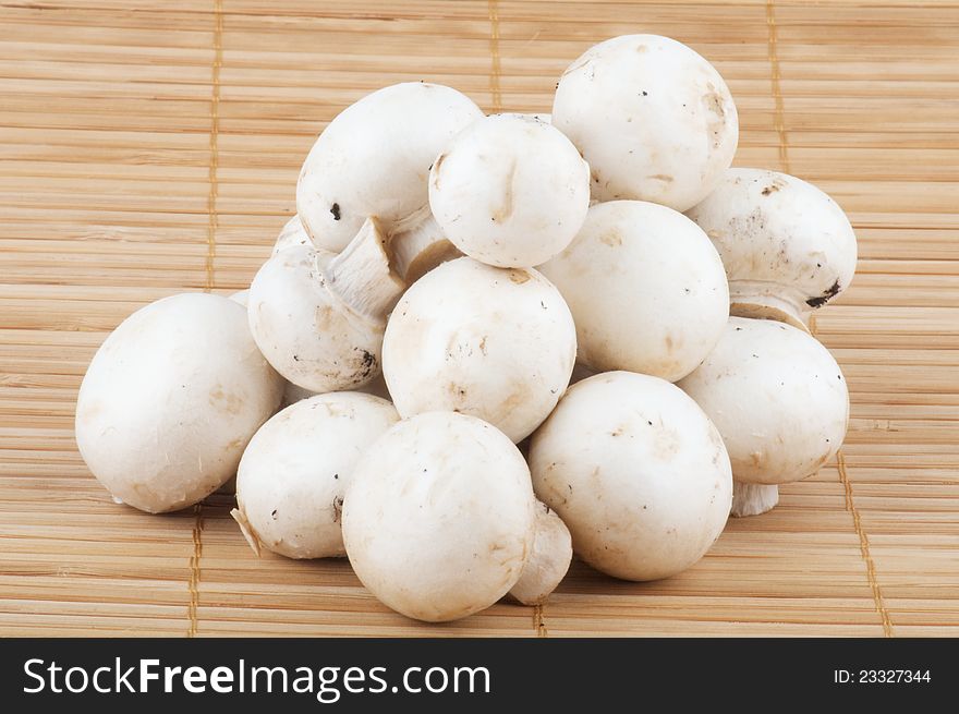 White Champignon Mushroom isolated on wooden background