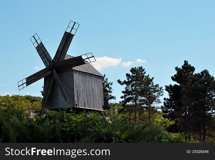 Old wooden mill near a monastery