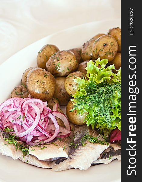 Marinated herring with potato and onion