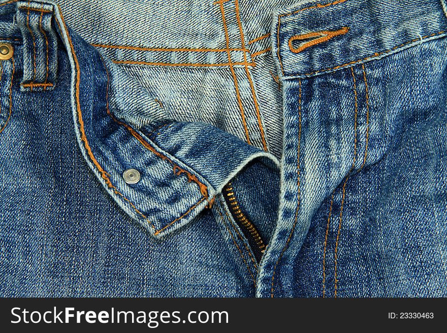 A close up image of a pair of unzipped blue jeans. A close up image of a pair of unzipped blue jeans