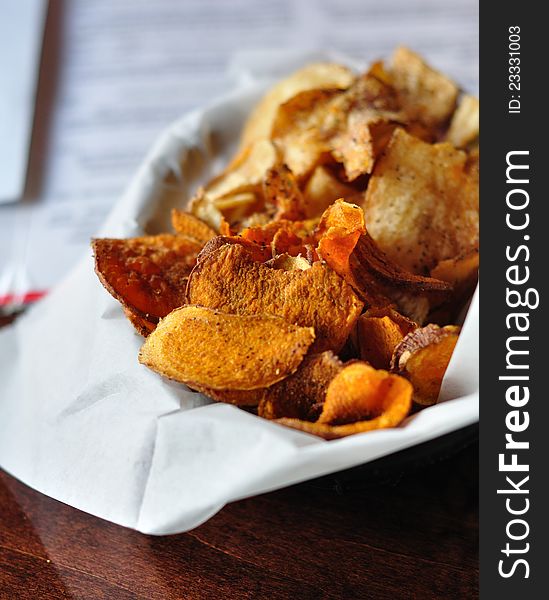 Fresh Cut Potato and Sweet Potato Chips served in a Restaurant. Fresh Cut Potato and Sweet Potato Chips served in a Restaurant