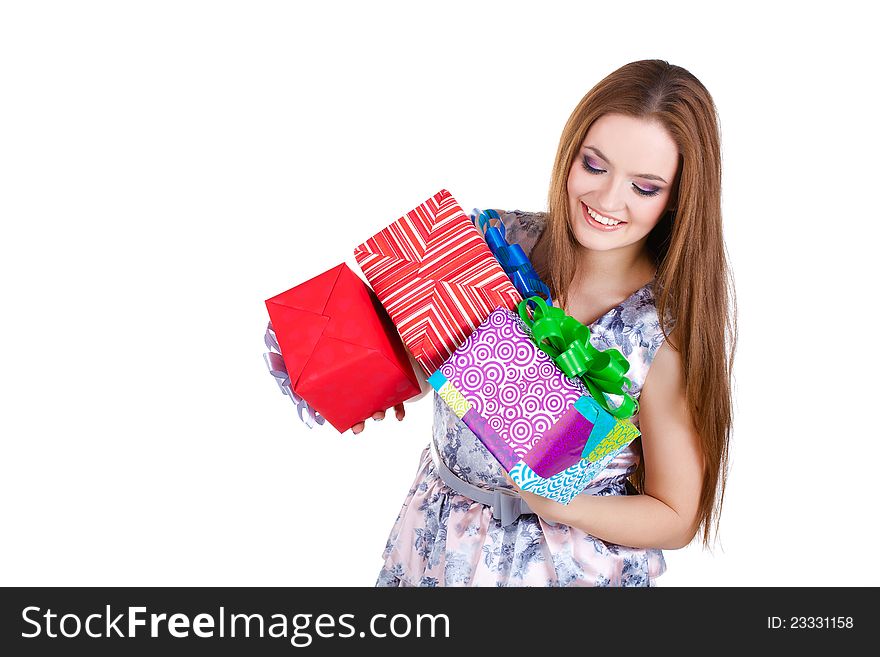 Beautiful girl holding gifts in studio in dress. Beautiful girl holding gifts in studio in dress