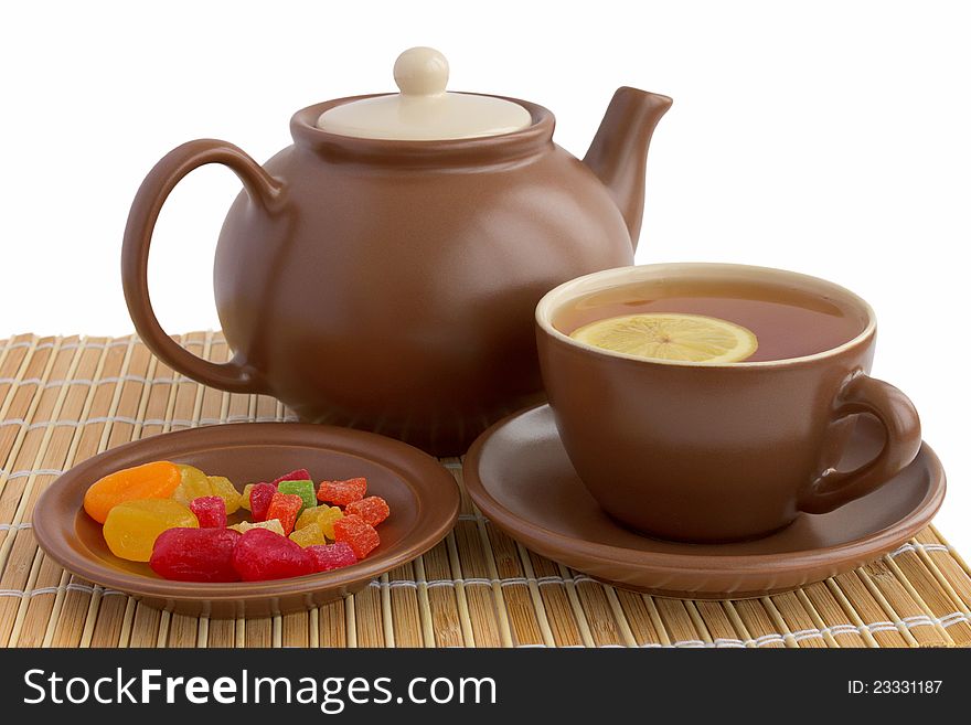 Ceramic teacup with teapot and candied fruits. Ceramic teacup with teapot and candied fruits