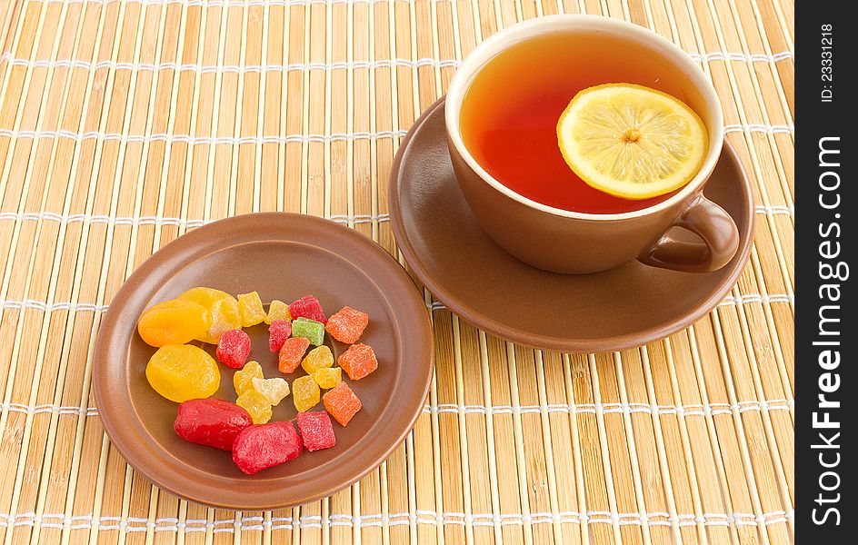 Ceramic teacup with lemon and candied fruits. Ceramic teacup with lemon and candied fruits