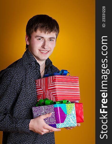 Present gift holding man looking smiling. Present gift holding man looking smiling