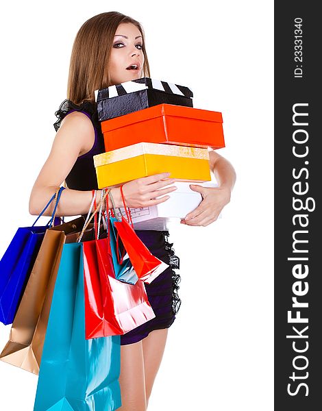 Beautiful young woman with shopping bags and gifts. isolated