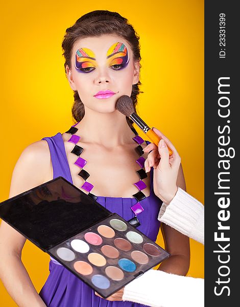 Beautiful young female face with bright fashion make-up