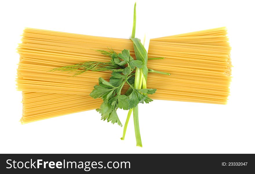 Bunch of raw pasta (spaghetti) tied with fresh green onion  on white background with copy space. Bunch of raw pasta (spaghetti) tied with fresh green onion  on white background with copy space