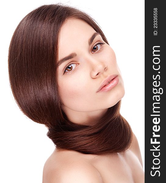 Studio portrait of attractive young woman with long hair on white background