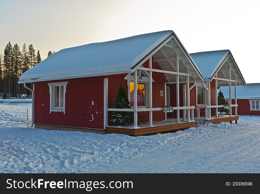 Wooden house in Lapland in winter landscape