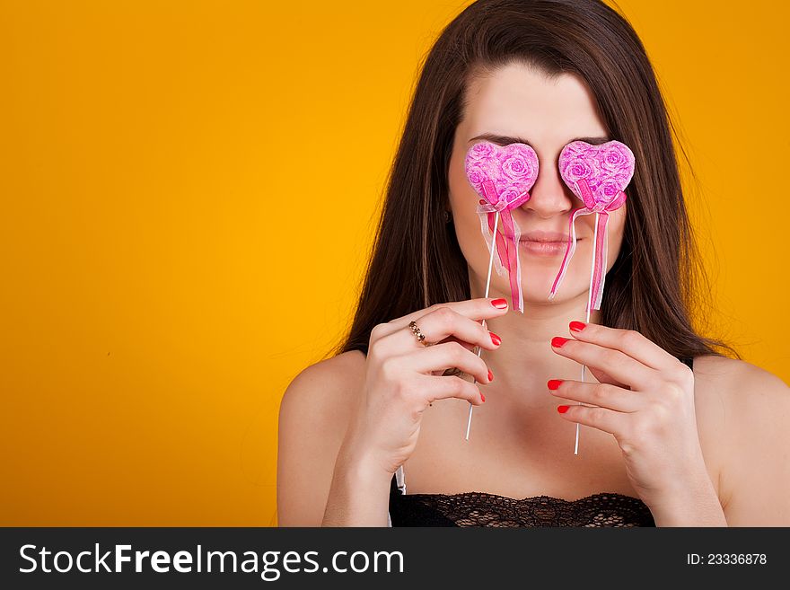 Beautiful young  woman with hearts in her hand