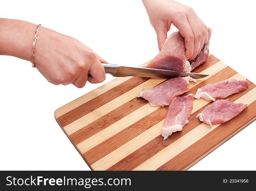 Process of cutting of pork on a board on a white background