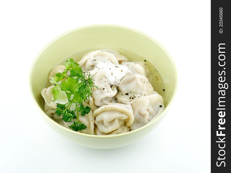 Meat pelmeni with sour cream and greens isolated on white background