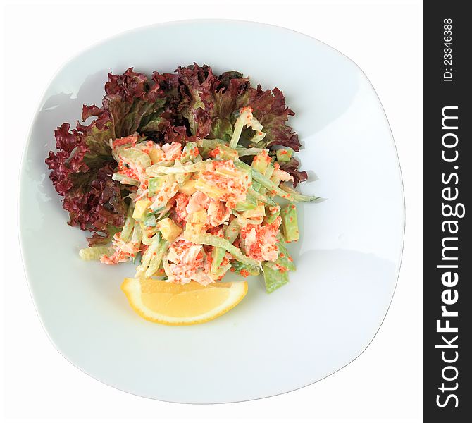 Salad California with avocado, crab, cucumber and tobiko on a white dish isolated on a white background. top view.