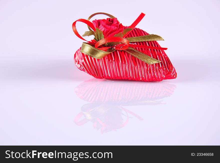 A heart shaped red gift on white. A heart shaped red gift on white