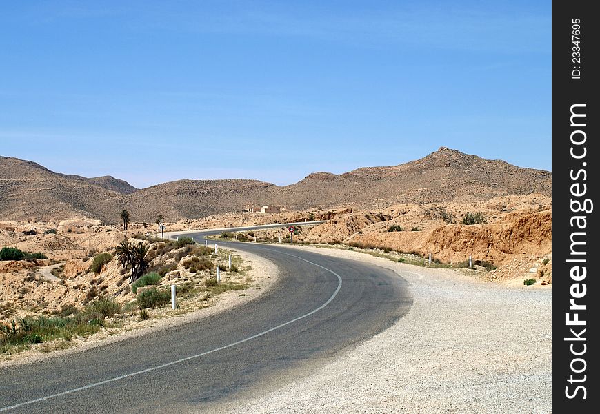 Desert highway among mountains in Tunisia. Desert highway among mountains in Tunisia