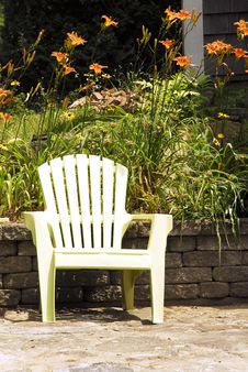 Garden Chair And Tiger Lilies Stock Images