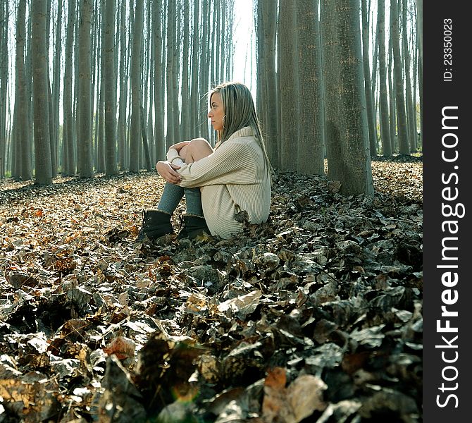 Beautiful Blonde Girl Thinking In The Woods