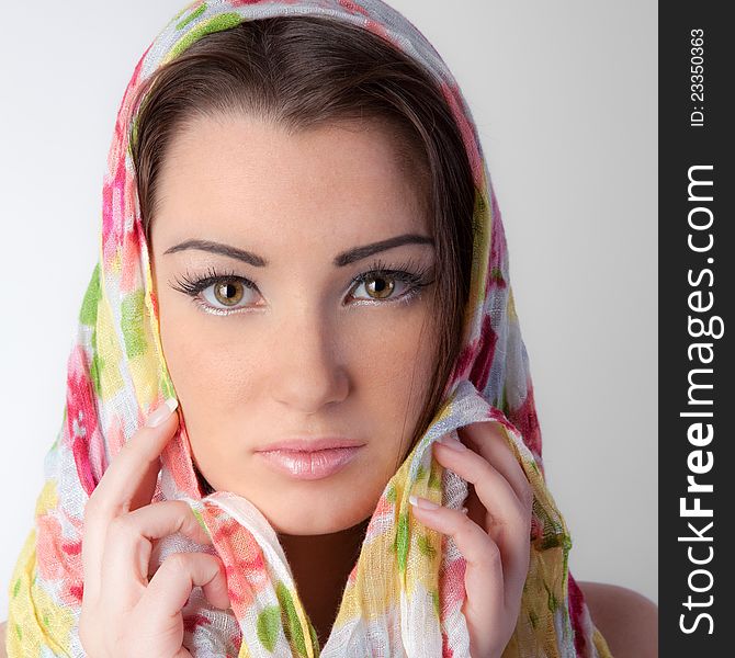 A soft, close-up portrait of a pretty young woman with bright eyes and a pretty pink scarf covering her head. A soft, close-up portrait of a pretty young woman with bright eyes and a pretty pink scarf covering her head
