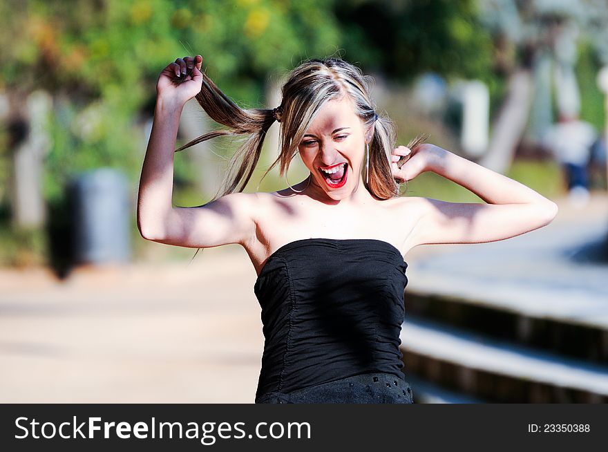 Beautiful and fashion girl with pigtails shouting and dancing