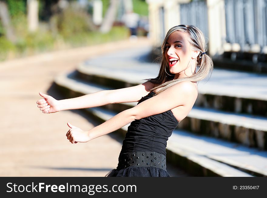 Beautiful and fashion girl with pigtails shouting and dancing