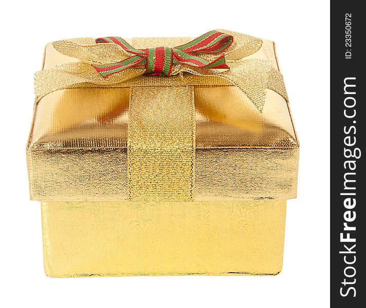 Closed gold gift box with bow and ribbon on a white background