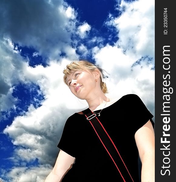 Beautiful blonde girl on blue sky background