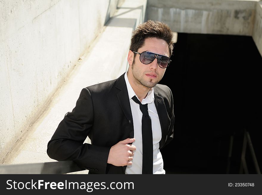 Portrait of a handsome young businessman with sunglasses