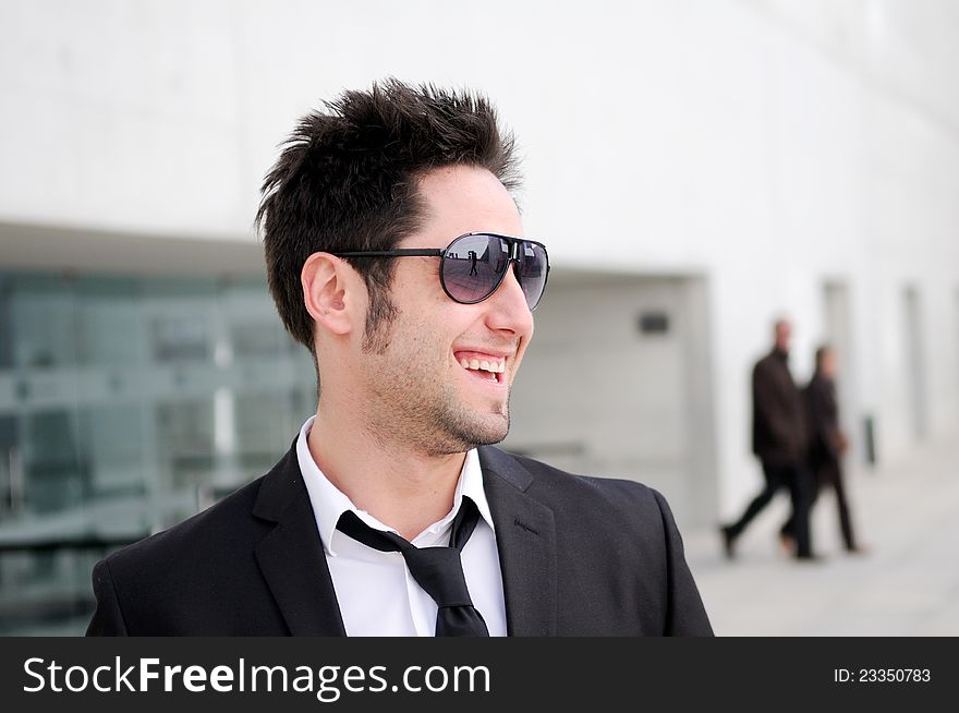 Portrait of a handsome young business man smiling. Portrait of a handsome young business man smiling