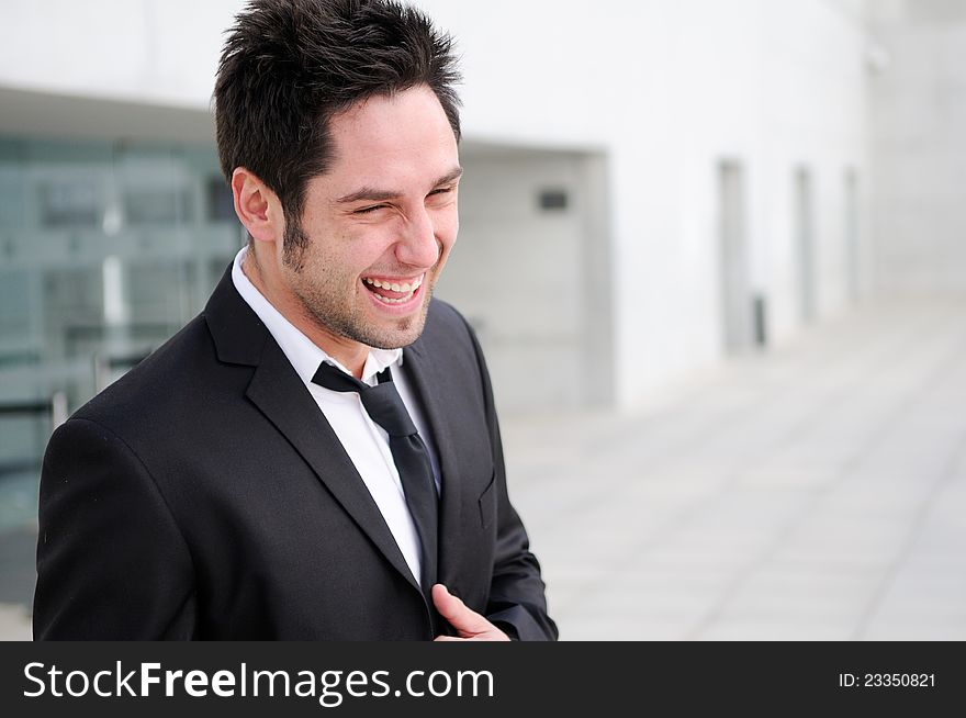 Attractive young businessman laughing