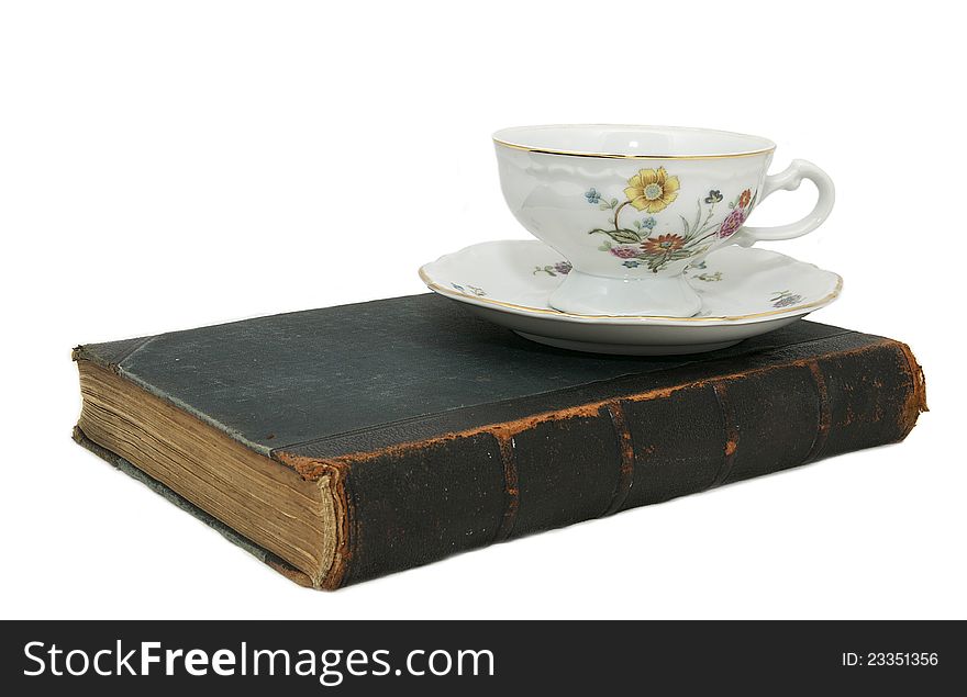 Book and a cup of china on a white background. Book and a cup of china on a white background