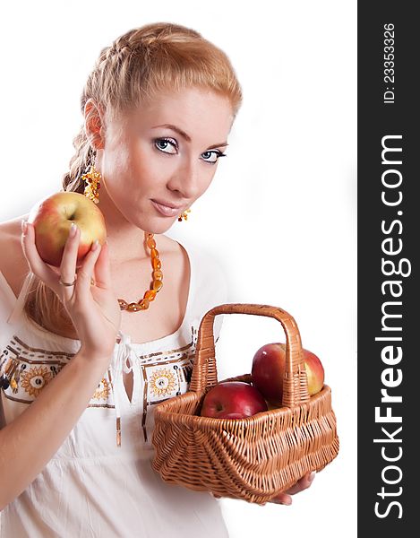 Redheaded woman with basket of apples over white