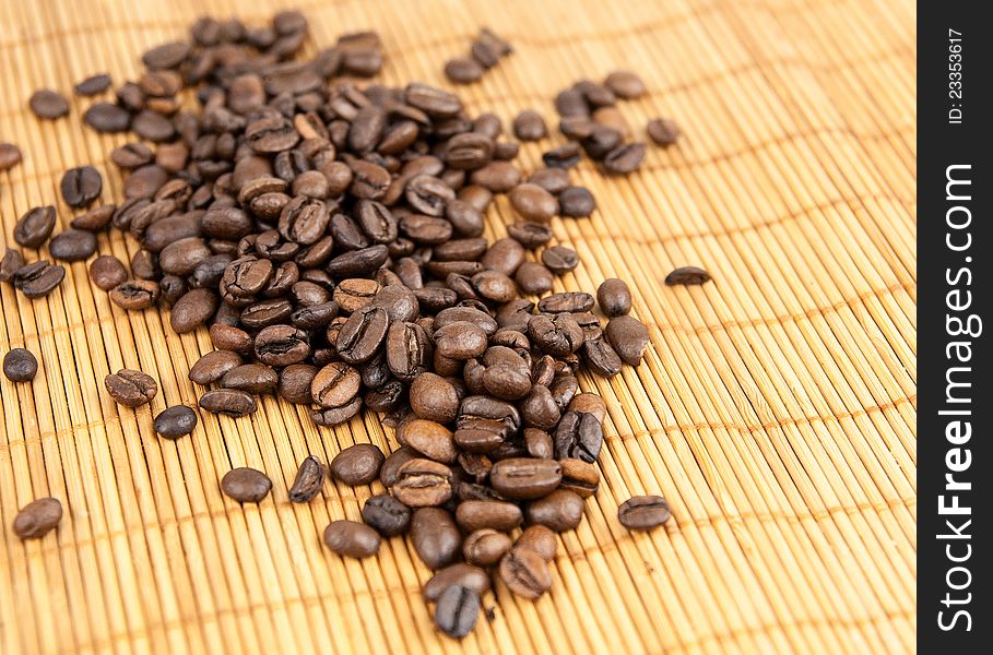 Coffee grains on a bamboo rug. Coffee grains on a bamboo rug