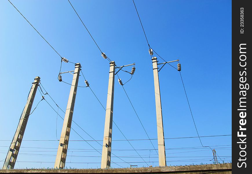 Wire poles on blue sky
