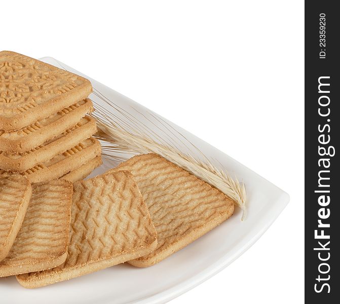 Crispy wheat biscuits with ears of wheat isolated on white background